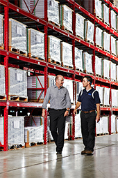 Two men walking in a warehouse